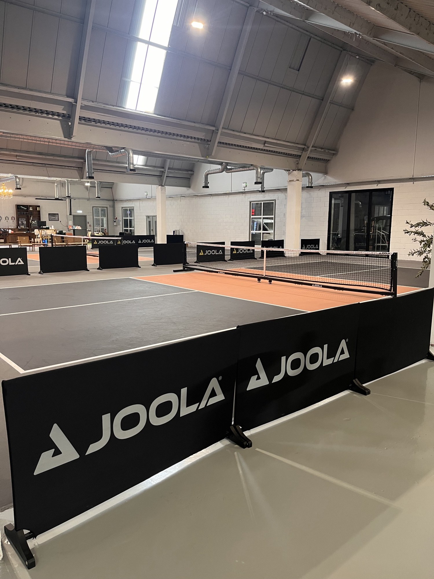 An indoor pickleball court with JOOLA nets