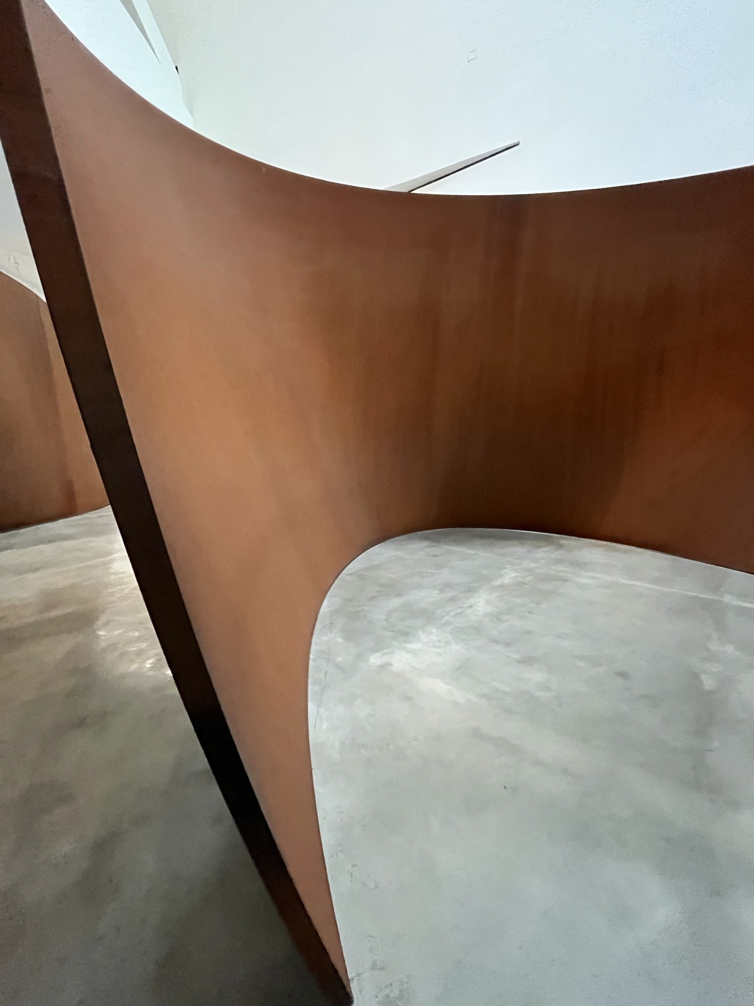 A large curving weathered-steel Richard Serra sculpture inside the Guggenheim