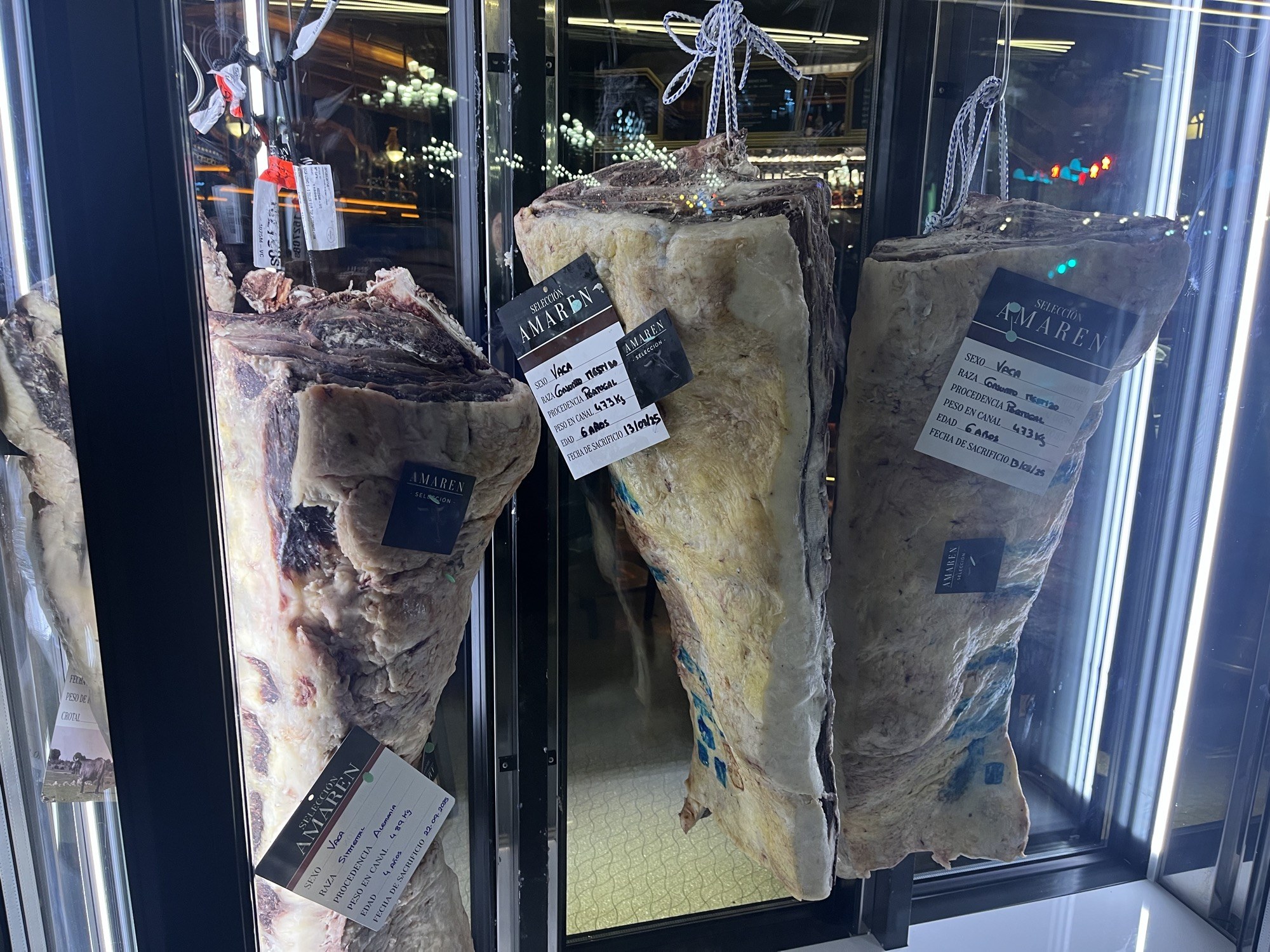Whole loins of beef ageing in a cabinet with Seleccion Amaren tags