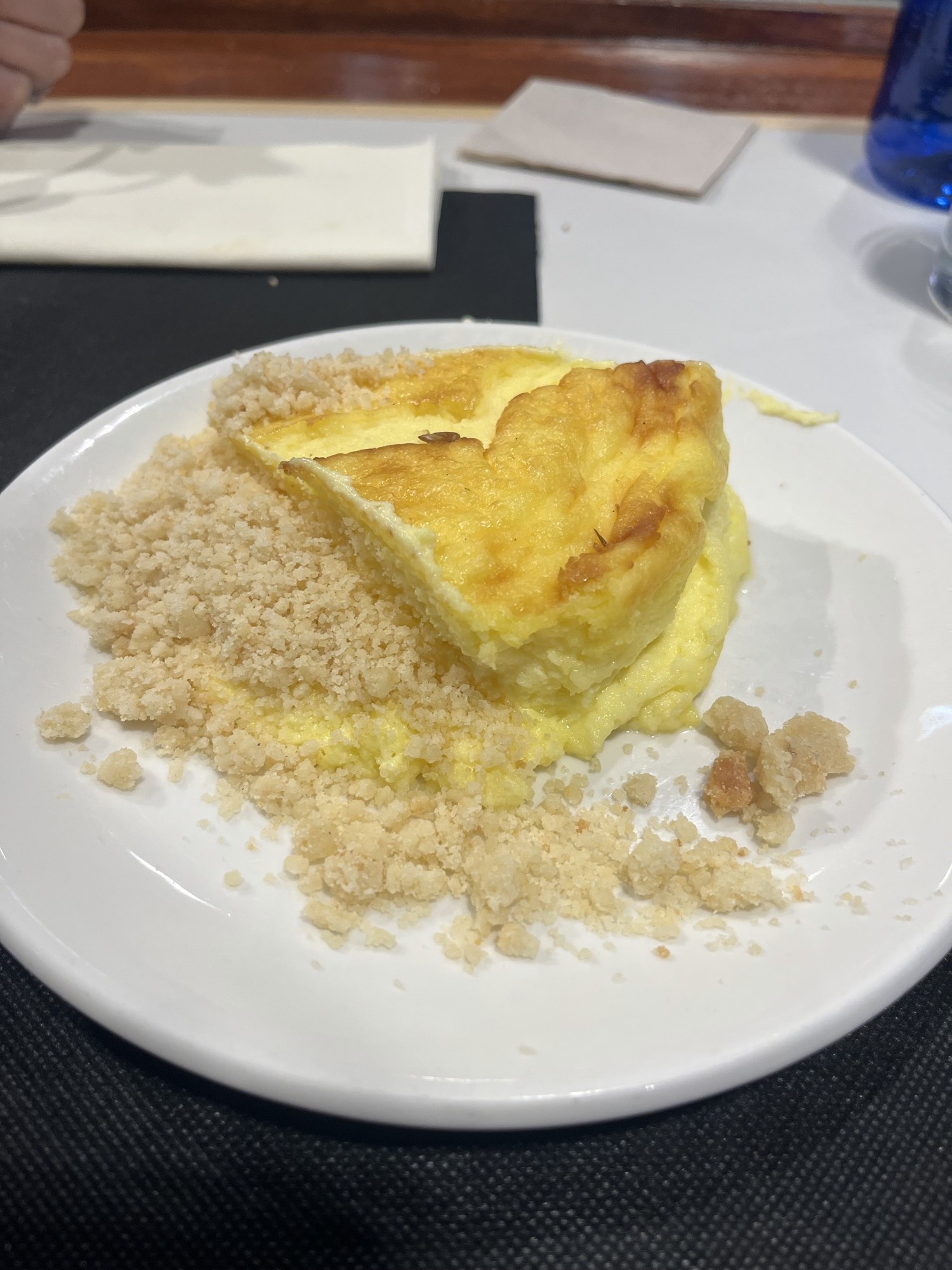 A wedge of Basque burnt cheesecake, browned on top and soft in the centre