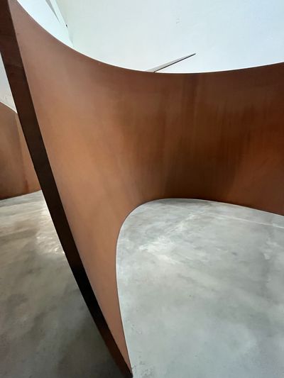 A large curving weathered-steel Richard Serra sculpture inside the Guggenheim