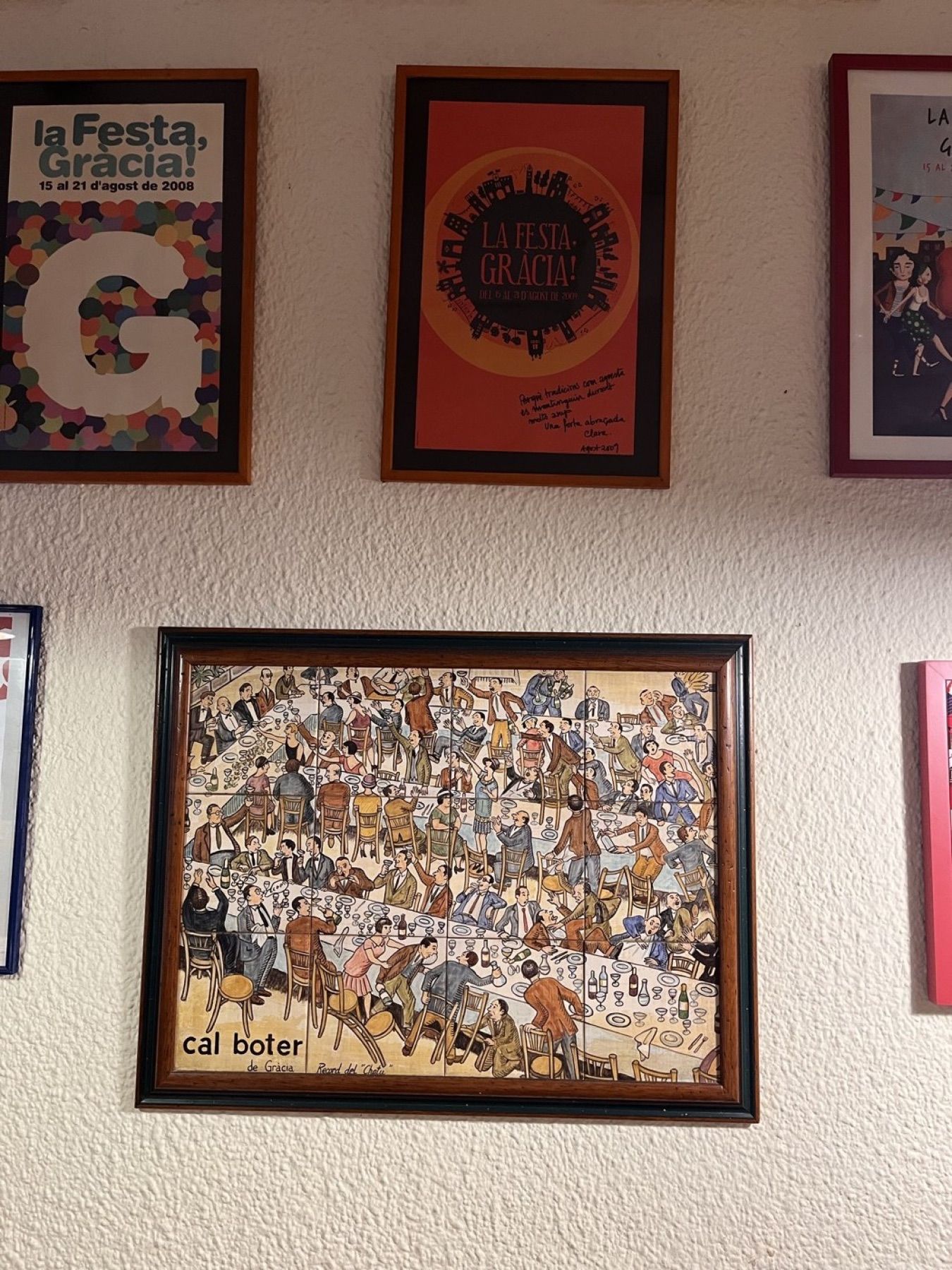 Cal Boter’s walls: festa posters, postcards, and the whole neighbourhood sat down at one table.
