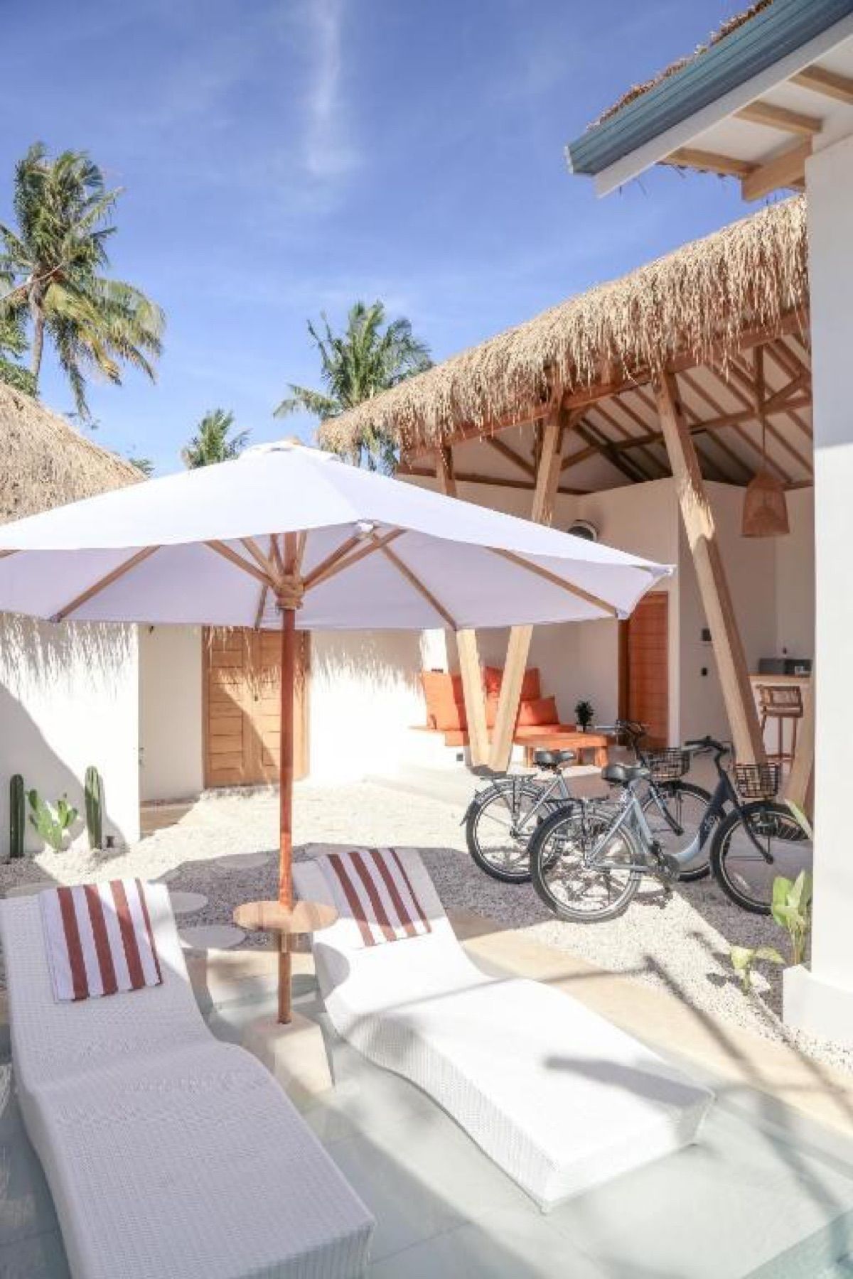 The pool, the umbrella and the two bikes by the door.
